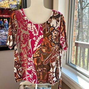 Chico’s Top multi colored with loop tie on bottom. Size 2 (Large)